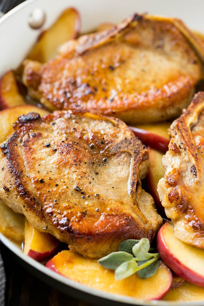 Apple Pork Chops Recipe | Pork Chops with Apples | Cider Pork Chops | Bone In Pork Chops Recipe #pork #porkchops #fall #apple #dinner #ezlod Seared pork in a pan in a sweet and savory sauce with fresh herbs.
