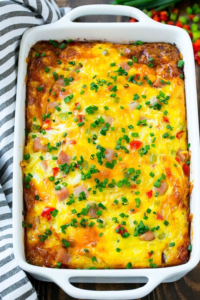 Hash Brown Egg Casserole Recipe | Breakfast Casserole with Ham | Hash Brown Casserole | Ham and Egg Casserole | Egg Casserole with Ham #casserole #breakfast #eggs #egg #hashbrown #ezlod Hash brown egg casserole in a white baking dish.
