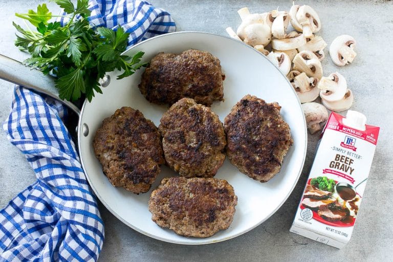 Slow Cooker Salisbury Steak Recipe | Homemade Salisbury Steak | Salisbury Steak from Scratch #steak #beef #salisbury #salisburysteak #slowcooker #crockpot #dinner #ezlod Hamburger patties browned in a skillet.