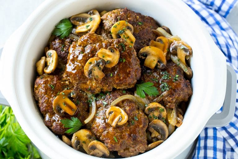 Slow Cooker Salisbury Steak Recipe | Homemade Salisbury Steak | Salisbury Steak from Scratch #steak #beef #salisbury #salisburysteak #slowcooker #crockpot #dinner #ezlod A crock pot full of slow cooker salisbury steak.