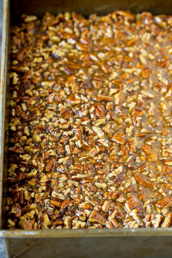 Pecan Pie Bars Recipe #pecans #pie #fall #pecanpie #dessert #thanksgiving #ezlod Pecans and brown sugar poured over a cookie crust.