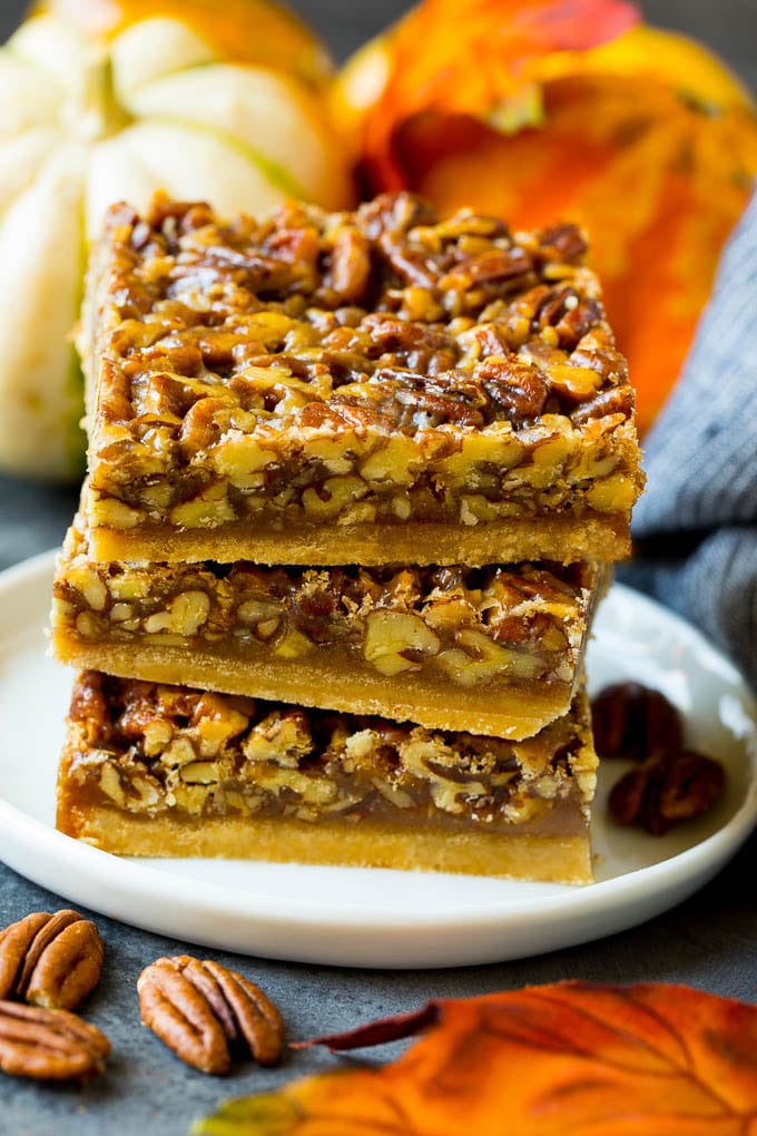 Pecan Pie Bars Recipe #pecans #pie #fall #pecanpie #dessert #thanksgiving #ezlod A stack of pecan pie bars on a plate.