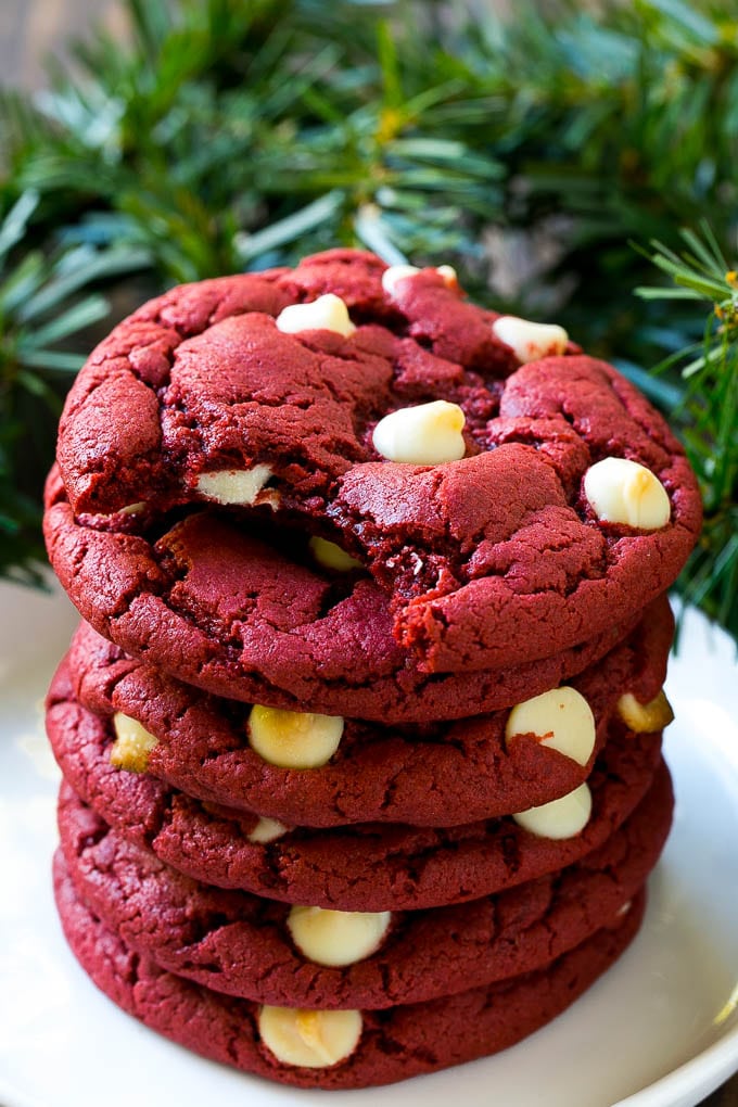 Red Velvet Cookies Recipe | Red Velvet Cookies with White Chocolate Chips | Red Velvet Cake Mix Cookies #redvelvet #cookies #whitechocolate #christmas #ezlod A stack of red velvet cookies on a plate.