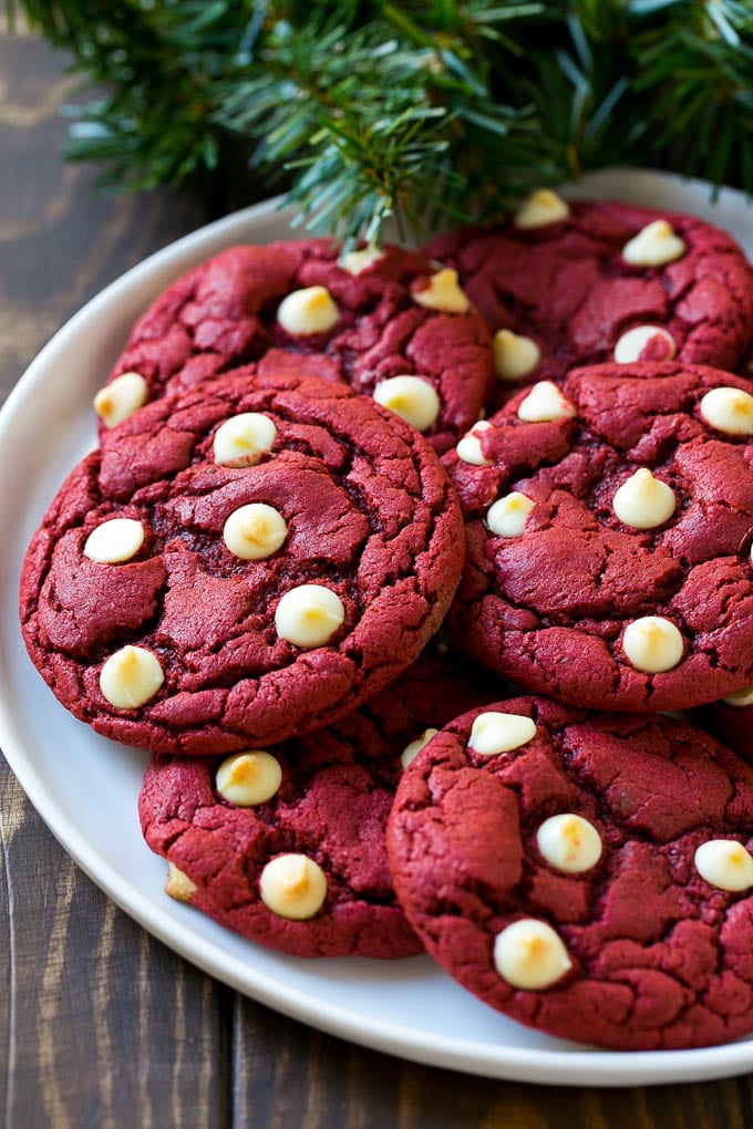 Red Velvet Cookies Recipe | Red Velvet Cookies with White Chocolate Chips | Red Velvet Cake Mix Cookies #redvelvet #cookies #whitechocolate #christmas #ezlod Red Velvet Cookies on a serving plate with holiday decorations nearby,