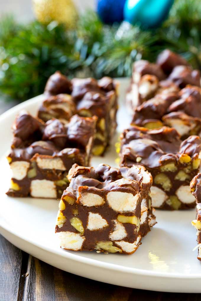 Rocky Road Fudge | Chocolate Marshmallow Fudge | Chocolate Nut Fudge | Microwave Fudge #fudge #chocolatefudge #nobake #chocolate #dessert #rockyroad #ezlod Squares of rocky road fudge on a serving plate.