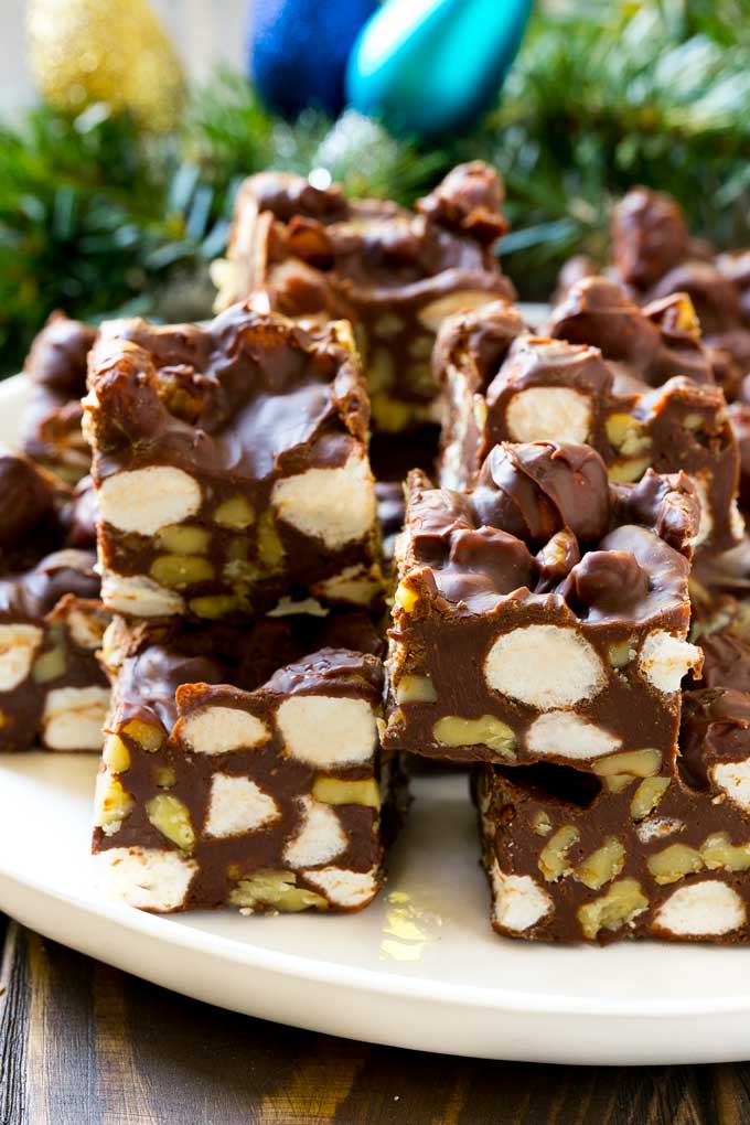 Rocky Road Fudge | Chocolate Marshmallow Fudge | Chocolate Nut Fudge | Microwave Fudge #fudge #chocolatefudge #nobake #chocolate #dessert #rockyroad #ezlod Rocky Road Fudge cut into squares on a serving plate.