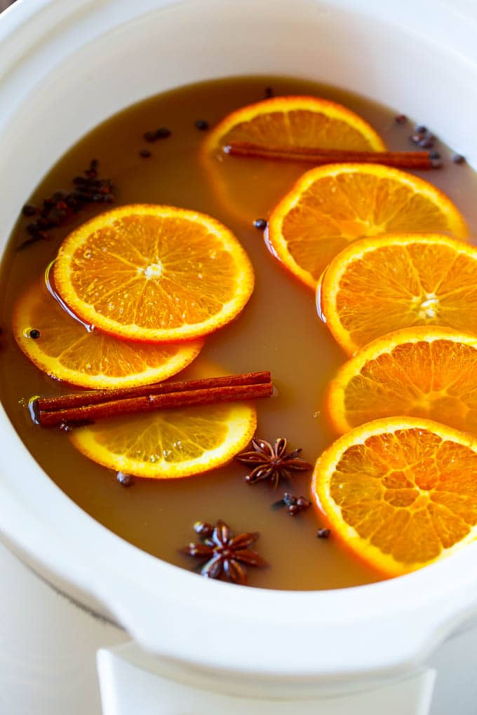 Slow Cooker Apple Cider | Mulled Apple Cider | Crockpot Apple Cider #cider #apple #applecider #drink #crockpot #slowcooker #ezlod Crock pot spiced drink with orange slices and aromatic spices.