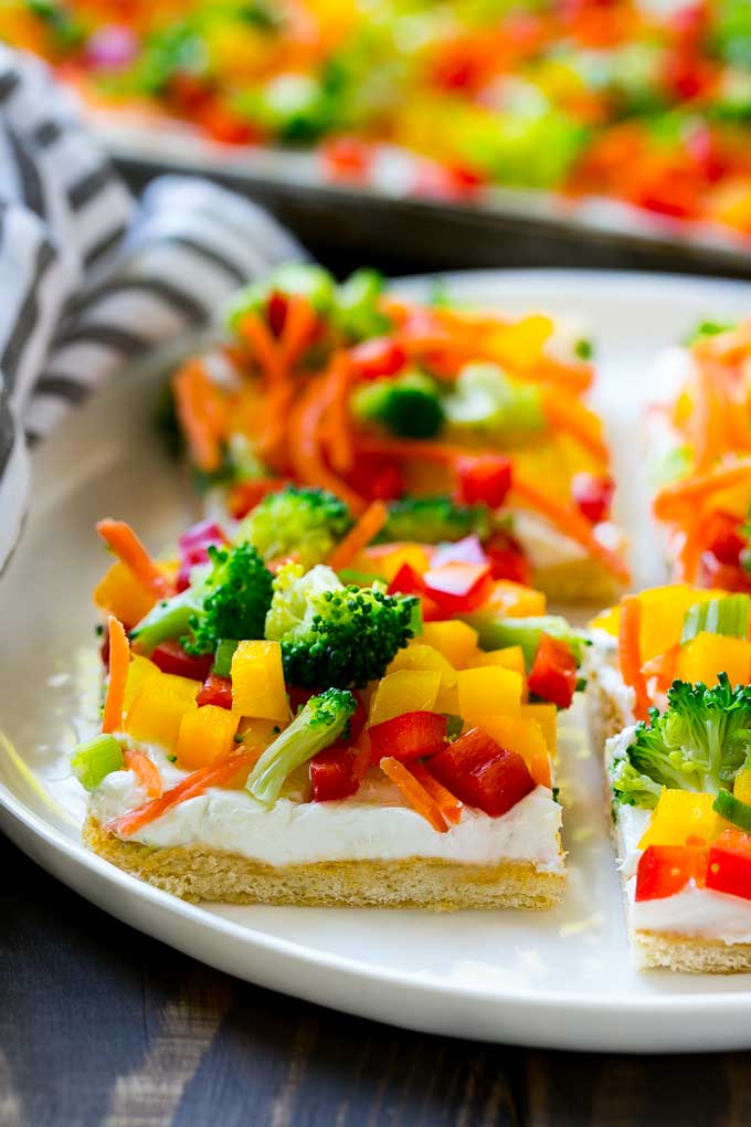 Veggie Pizza Recipe | Crescent Veggie Pizza | Vegetable Pizza Recipe | Holiday Appetizer | Homemade Veggie Pizza #pizza #veggies #vegetarian #appetizer #ezlod Slices of veggie pizza on a serving plate.