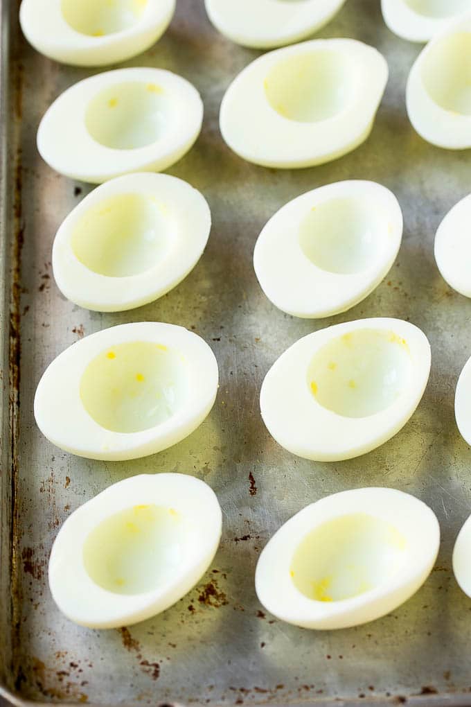 Bacon Deviled Eggs | Deviled Eggs Recipe #eggs #keto #lowcarb #bacon #appetizer #ezlod Egg white halves on a sheet pan.