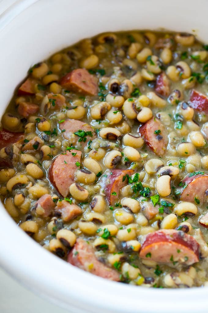 Slow Cooker Black Eyed Peas Recipe | Crock Pot Black Eyed Peas | Southern Black Eyed Peas | Black Eyed Peas with Ham | Black Eyed Peas with Sausage #blackeyedpeas #slowcooker #crockpot #sausage #newyears #dinner #ezlod These crock pot black eyed peas with sausage and ham are the perfect meal for new years.