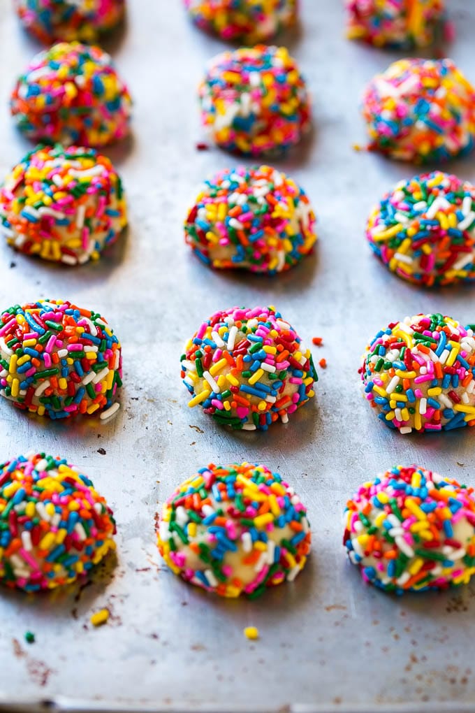 Funfetti Cookies Recipe | Funfetti Cake Mix Cookies | Sprinkle Cookies | Cake Mix Cookies #cookies #funfetti #sprinkles #dessert #ezlod Balls of cookie dough coated in sprinkles.
