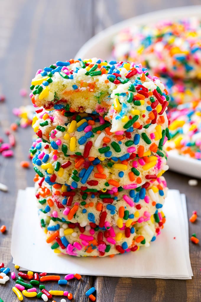Funfetti Cookies Recipe | Funfetti Cake Mix Cookies | Sprinkle Cookies | Cake Mix Cookies #cookies #funfetti #sprinkles #dessert #ezlod A stack of funfetti cookies with a bite taken out of one.