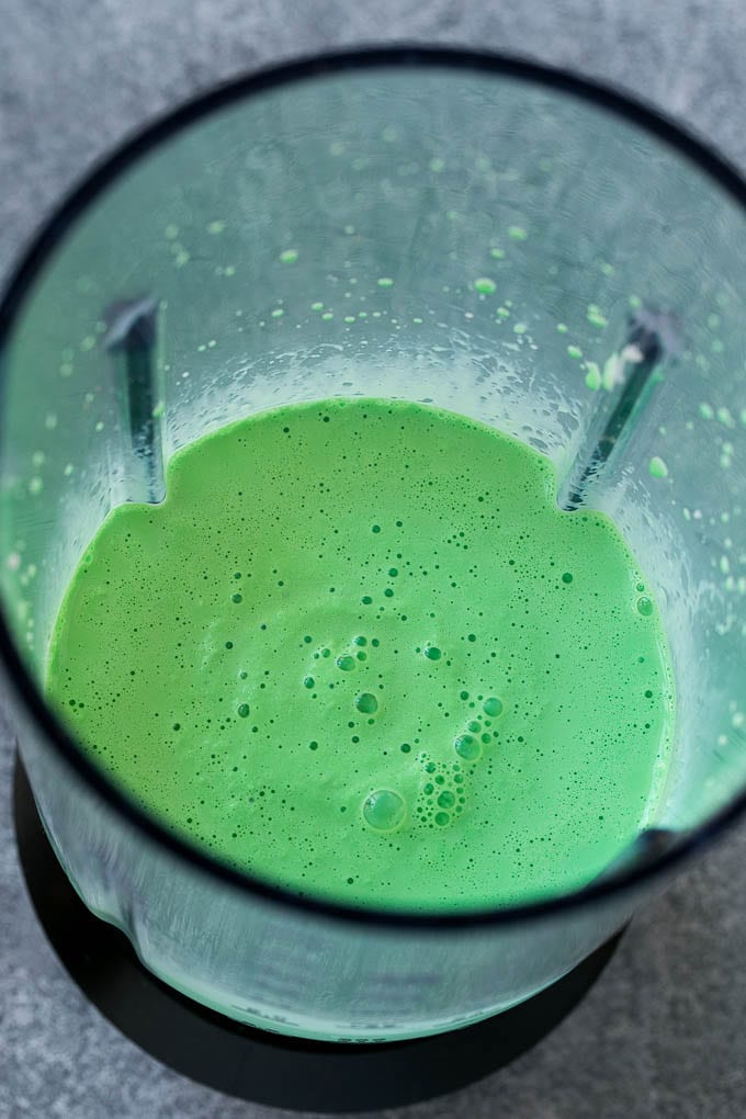 Shamrock Shake Recipe | McDonald's Shamrock Shake | Saint Patrick's Day Drink | Mint Milkshake #milkshake #stpatricksday #saintpatricksday #mint #ezlod Green milkshake in a blender.