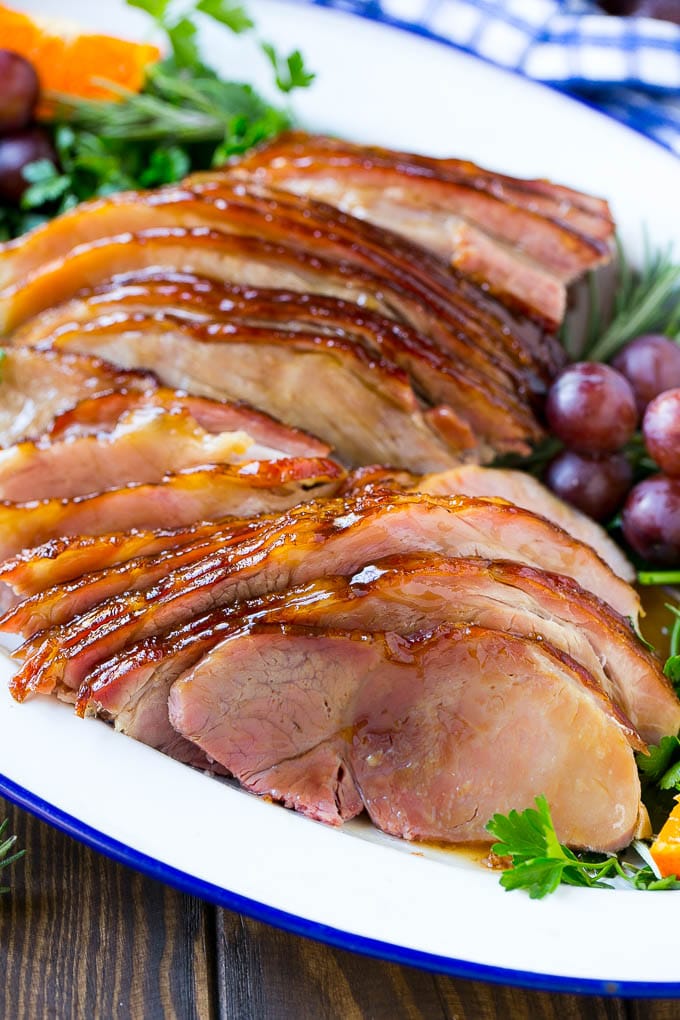Coca Cola Ham | Coke Glazed Ham | Easter Ham | Christmas Ham | Holiday Ham Recipe #ham #easter #christmas #dinner #ezlod A platter of sliced coca cola ham with herbs.