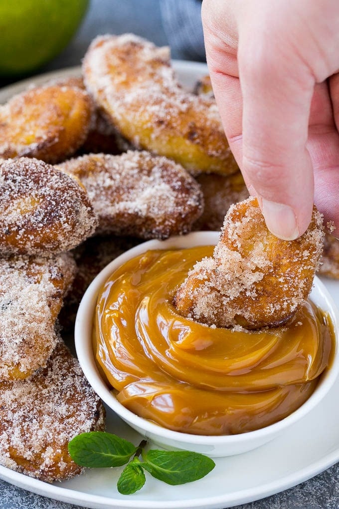 Apple Fries Recipe | Fried Apples Recipe | Cinnamon Sugar Apples | Apple Dessert Recipe #apples #dessert #ezlod #fall An apple fry being dipped into caramel sauce.