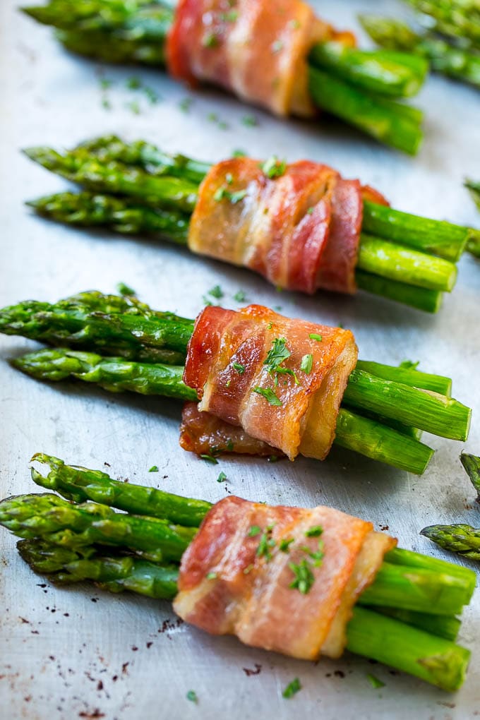 Bacon Wrapped Asparagus Recipe | Roasted Asparagus | Asparagus Side Dish #asparagus #bacon #sidedish #dinner #ezlod Roasted asparagus in bundles on a sheet pan.