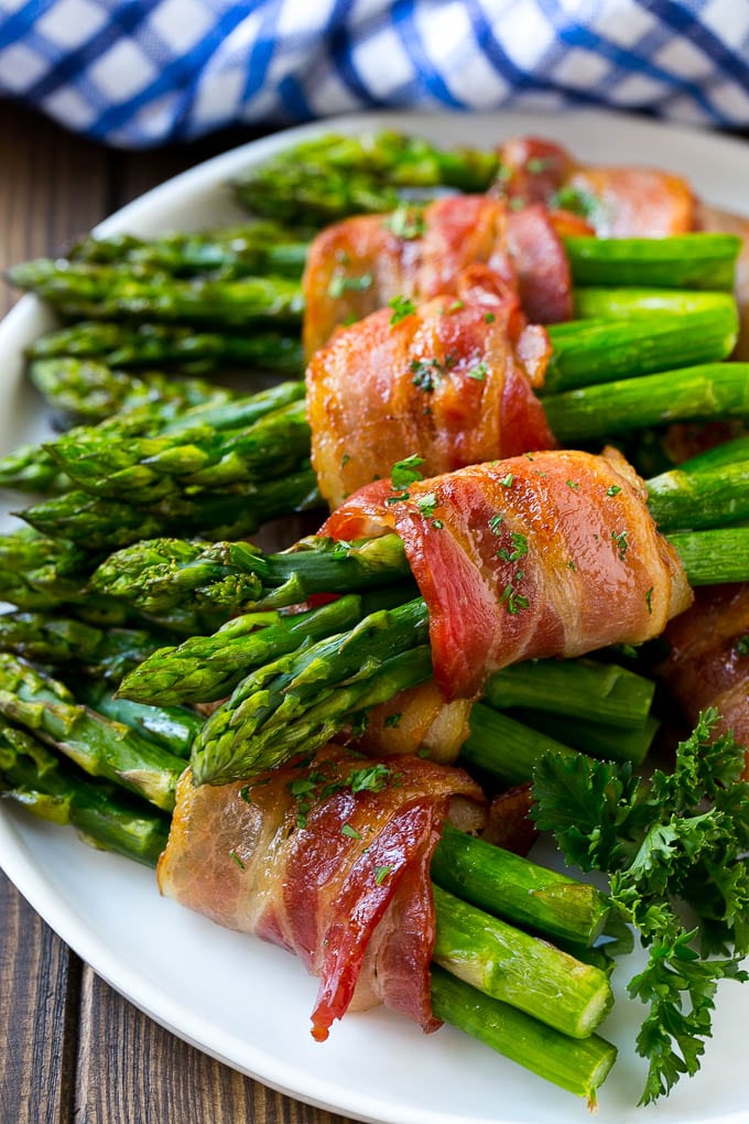 Bacon Wrapped Asparagus Recipe | Roasted Asparagus | Asparagus Side Dish #asparagus #bacon #sidedish #dinner #ezlod Bacon wrapped asparagus on a serving plate.