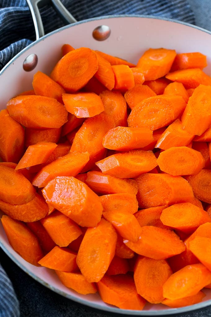 Candied Carrots Recipe | Carrot Side Dish | Brown Sugar Carrots | Glazed Carrots #carrots #brownsugar #sidedish #dinner #ezlod Raw sliced carrots in a pan.