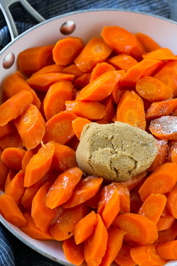 Candied Carrots Recipe | Carrot Side Dish | Brown Sugar Carrots | Glazed Carrots #carrots #brownsugar #sidedish #dinner #ezlod Sliced carrots with butter, brown sugar and seasonings in a pan.