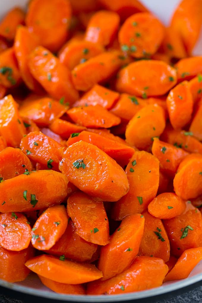 Candied Carrots Recipe | Carrot Side Dish | Brown Sugar Carrots | Glazed Carrots #carrots #brownsugar #sidedish #dinner #ezlod A close up of cooked candied carrots topped with parsley.