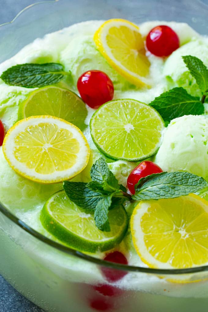 Lime Sherbet Punch | Party Punch Recipe | Sherbet Punch Recipe | Limeade Recipe #sherbet #punch #lime #drink #ezlod A close up of a bowl of sherbet punch garnished with citrus and mint.