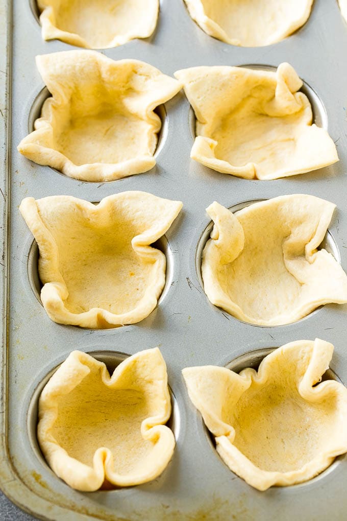 Pizza Muffins Recipe | Pizza Bites | Pizza Cups | Pizza Appetizer #pizza #appetizer #ezlod Crescent roll dough pressed into a tin forms the crust.