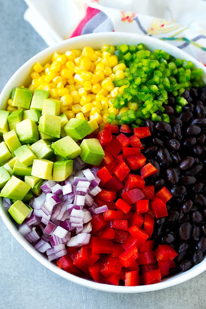 Black Bean and Corn Salad Recipe | Mexican Salad | Black Bean Salad | Bean Salad #salad #beans #corn #mexicanfood #ezlod A bowl of beans, corn, diced red peppers, minced jalapeno, red onion and avocado.