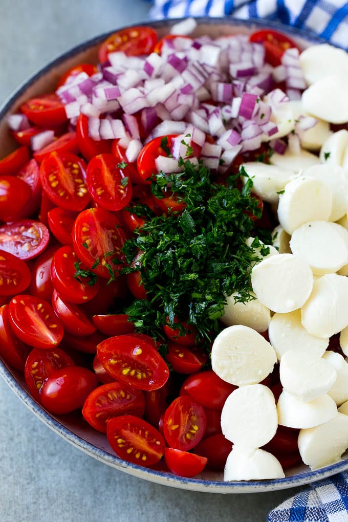 Cherry Tomato Salad Recipe | Tomato Mozzarella Salad | Caprese Salad | Tomato Salad #tomatoes #salad #tomatosalad #caprese #ezlod A bowl of halved cherry tomatoes, mozzarella balls, herbs and minced red onion.
