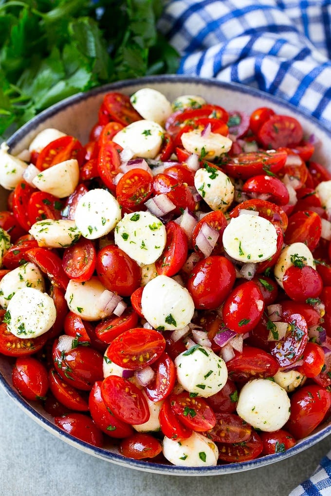 Cherry Tomato Salad Recipe | Tomato Mozzarella Salad | Caprese Salad | Tomato Salad #tomatoes #salad #tomatosalad #caprese #ezlod A serving bowl of tomato mozzarella salad with cherry tomatoes, herbs and red onion.
