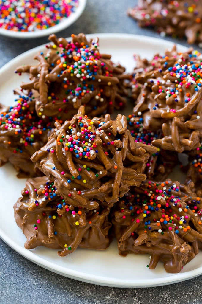 Haystack Cookies Recipe | No Bake Cookies | Chow Mein Noodle Cookies #nobakecookies #cookies #recipe #chocolate #ezlod A plate of haystack cookies topped with rainbow sprinkles.