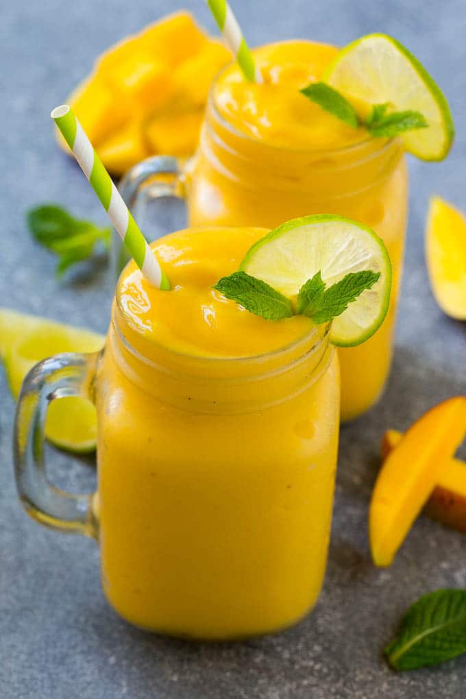 Mango Smoothie Recipe | Mango Recipe | Healthy Smoothie #mango #smoothie #drink #ezlod Mango smoothie in a mug topped with a slice of lime and mint sprig.