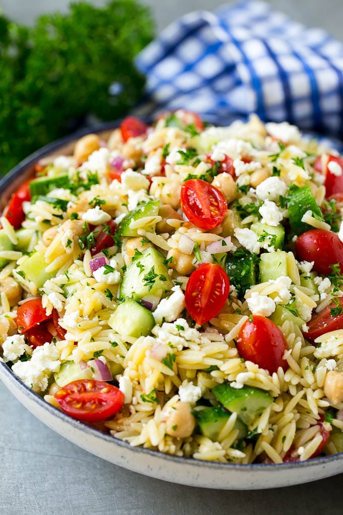 Orzo Salad Recipe | Orzo Pasta Salad | Greek Orzo Salad | Mediterranean Orzo Salad #pastasalad #orzo #greekfood #salad #ezlod Orzo salad in a serving bowl with tomatoes, cucumbers and chickpeas.