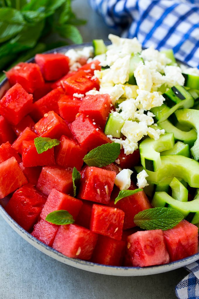 Watermelon Salad Recipe | Watermelon Feta Salad | Watermelon Cucumber Salad #watermelon #cucumber #salad #ezlod A bowl of watermelon, cucumber, feta cheese and mint leaves drizzled with lime dressing.