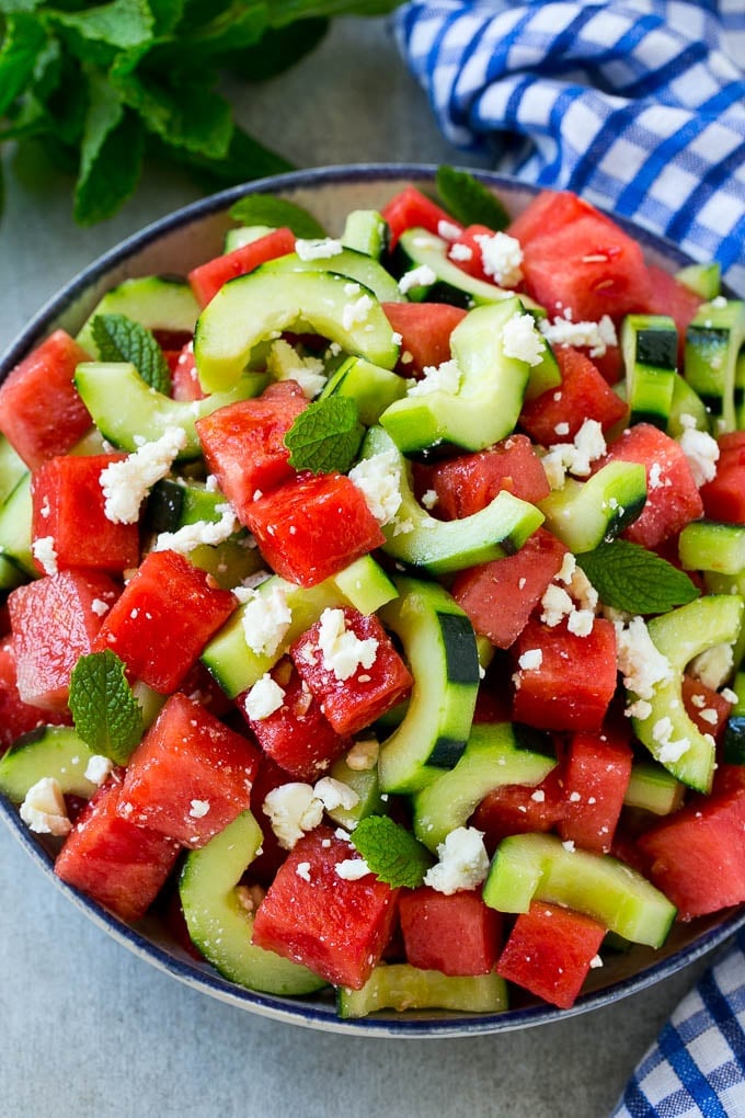 Watermelon Salad Recipe | Watermelon Feta Salad | Watermelon Cucumber Salad #watermelon #cucumber #salad #ezlod A bowl of watermelon feta salad with sliced cucumbers and mint leaves.