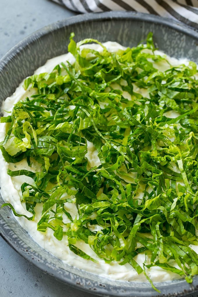 BLT Dip Recipe | Bacon Dip Recipe | Ranch Dip #dip #ranch #bacon #lettuce #tomato #appetizer #ezlod Shredded romaine lettuce over a sour cream, cream cheese and ranch powder base.