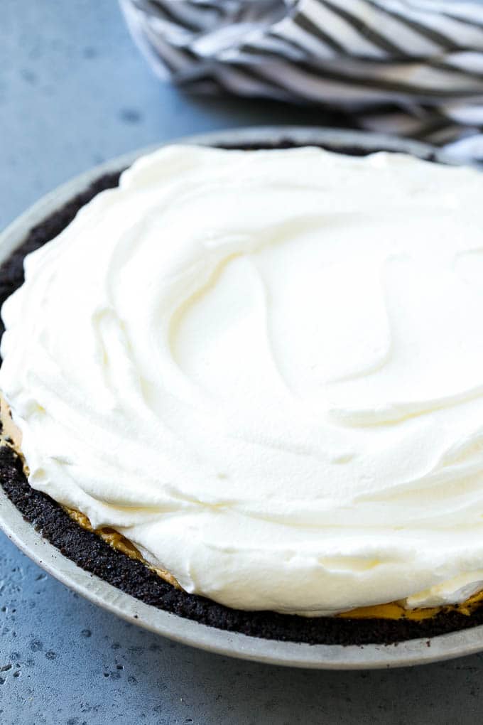 Chocolate Peanut Butter Pie Recipe | Peanut Butter Cup Pie | Peanut Butter Pie | No Bake Pie #chocolate #peanutbutter #pie #nobake #dessert #ezlod Whipped cream topping on top of a nut butter tart.