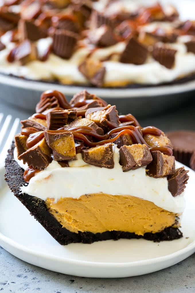 Chocolate Peanut Butter Pie Recipe | Peanut Butter Cup Pie | Peanut Butter Pie | No Bake Pie #chocolate #peanutbutter #pie #nobake #dessert #ezlod A slice of chocolate peanut butter pie topped with whipped cream, chocolate sauce and peanut butter cups.