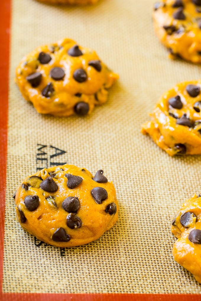 Pumpkin Chocolate Chip Cookies Recipe | Pumpkin Cookies | Pumpkin Chocolate Cookies #pumpkin #cookies #chocolate #baking #fall #ezlod #dessert Dollops of dough on a baking sheet.