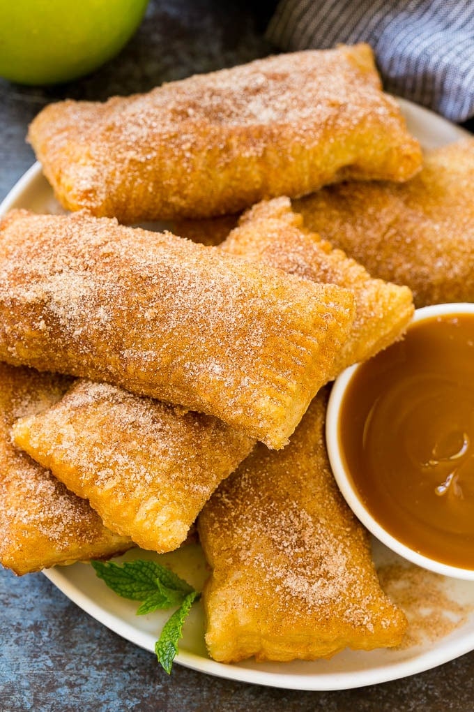 Fried Apple Pies Recipe | McDonald's Copycat Recipe | Apple Pie | Apple Hand Pies #pie #apples #applepie #dessert #snack #ezlod A plate of deep fried apple pies dusted with cinnamon sugar.