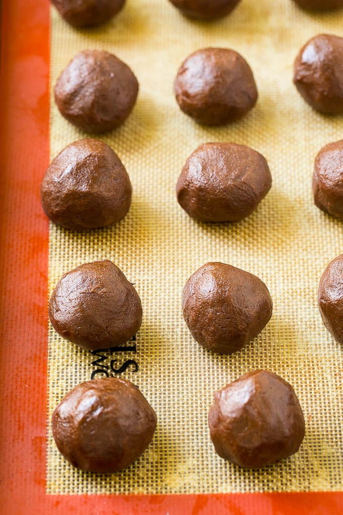 Nutella Cookies Recipe | Nutella Stuffed Cookies | Chocolate Cookies #nutella #chocolate #cookies #baking #dessert #ezlod Balls of chocolate cookie dough on a baking sheet.