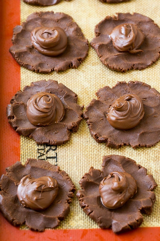 Nutella Cookies Recipe | Nutella Stuffed Cookies | Chocolate Cookies #nutella #chocolate #cookies #baking #dessert #ezlod Cookie dough with dollops of nutella in the center.