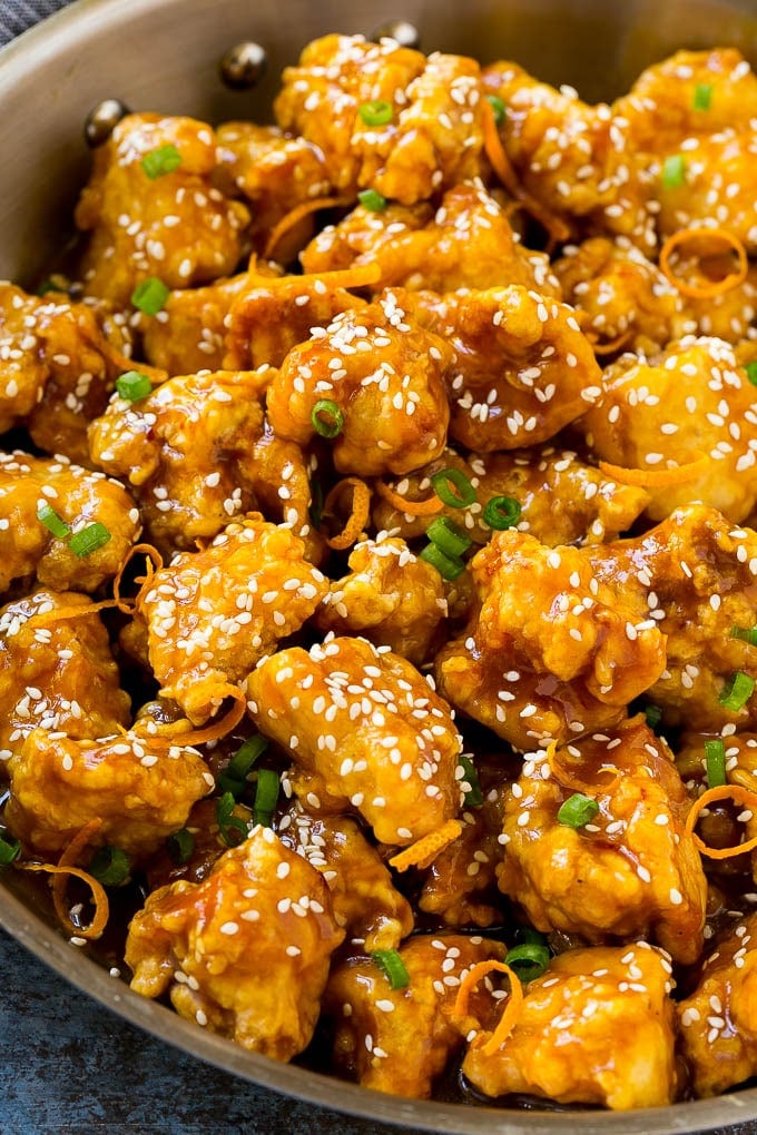 Orange Chicken Recipe | Chinese Orange Chicken | Panda Express Orange Chicken #orange #chicken #takeout #chinesefood #dinner #ezlod Orange chicken in a skillet with crispy chicken, sesame seeds, orange zest and green onions.