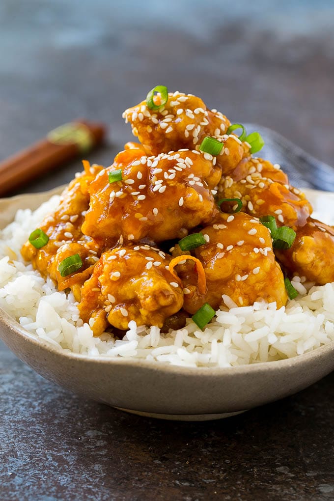 Orange Chicken Recipe | Chinese Orange Chicken | Panda Express Orange Chicken #orange #chicken #takeout #chinesefood #dinner #ezlod A bowl of orange chicken served over steamed rice and topped with sesame seeds.