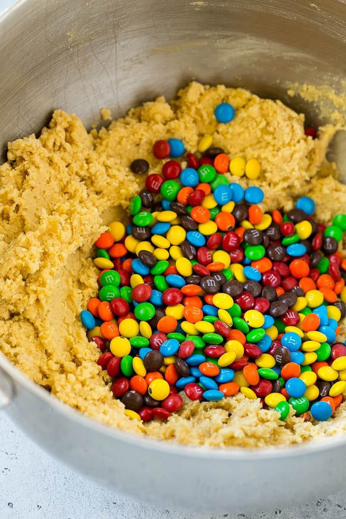 Oreo Stuffed Cookies Recipe | M&M's cookies | Stuffed Cookies #cookies #chocolate #oreos #dessert #baking #ezlod Cookie dough in a mixing bowl with miniature M&M's in it.