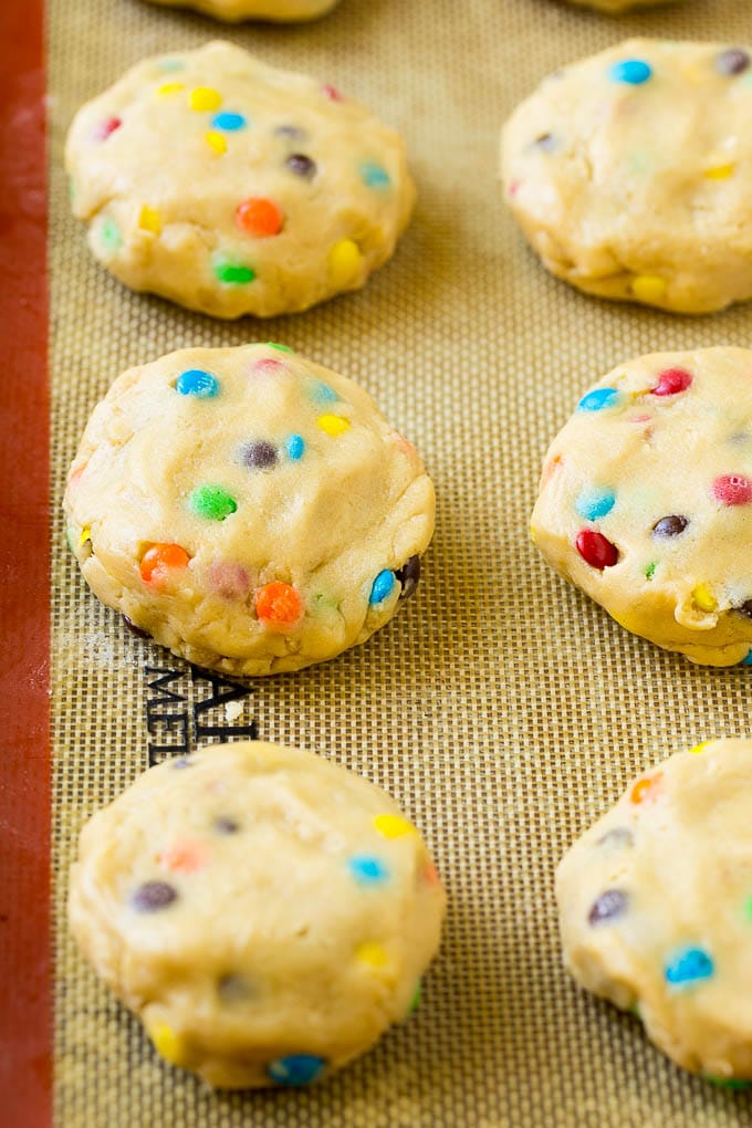 Oreo Stuffed Cookies Recipe | M&M's cookies | Stuffed Cookies #cookies #chocolate #oreos #dessert #baking #ezlod Cookie dough balls stuffed with Oreo cookies on a sheet pan.