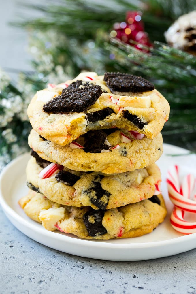 Oreo Peppermint Cookies Recipe | Candy Cane Cookies | Oreo Cookies #oreo #peppermint #cookies #baking #Christmas #sweets #ezlod A stack of Oreo peppermint cookies on a plate, garnished with candy canes.