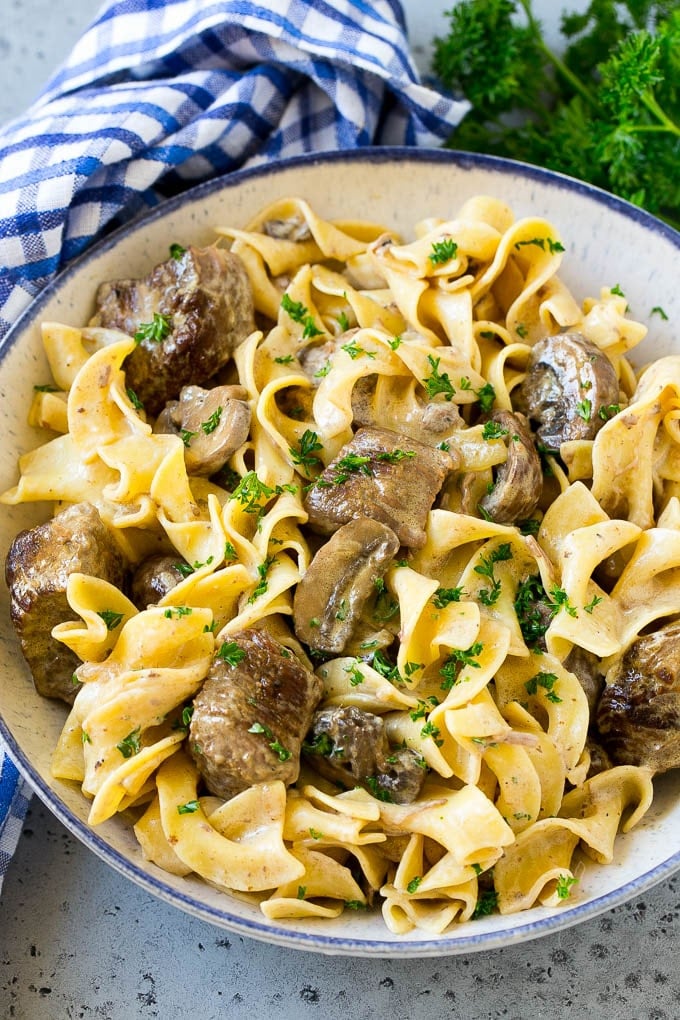 Slow Cooker Beef Stroganoff Recipe | Crock Pot Beef Stroganoff | Beef Recipe #slowcooker #crockpot #beef #mushrooms #pasta #dinner #ezlod A bowl of slow cooker beef stroganoff with egg noodles.
