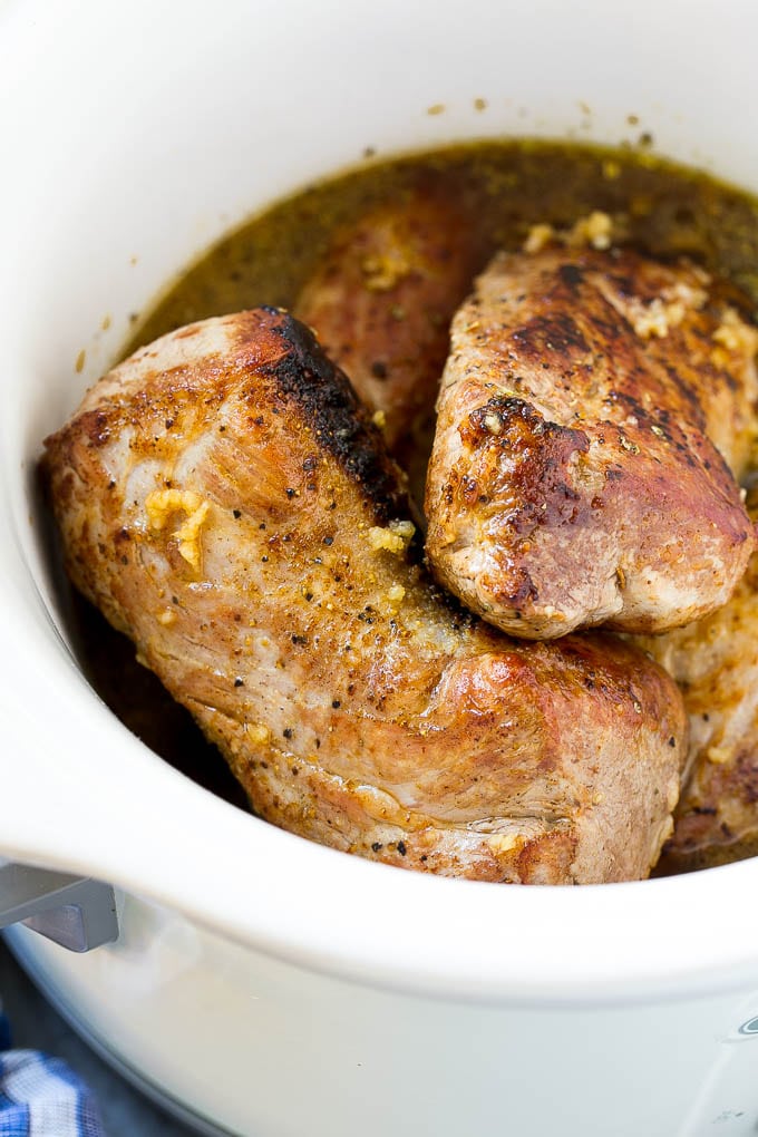 Slow Cooker Pork Tenderloin Recipe | Crock Pot Pork Tenderloin | Easy Pork Tenderloin #slowcooker #crockpot #pork #dinner #ezlod Seared pork tenderloin in a slow cooker with seasonings.