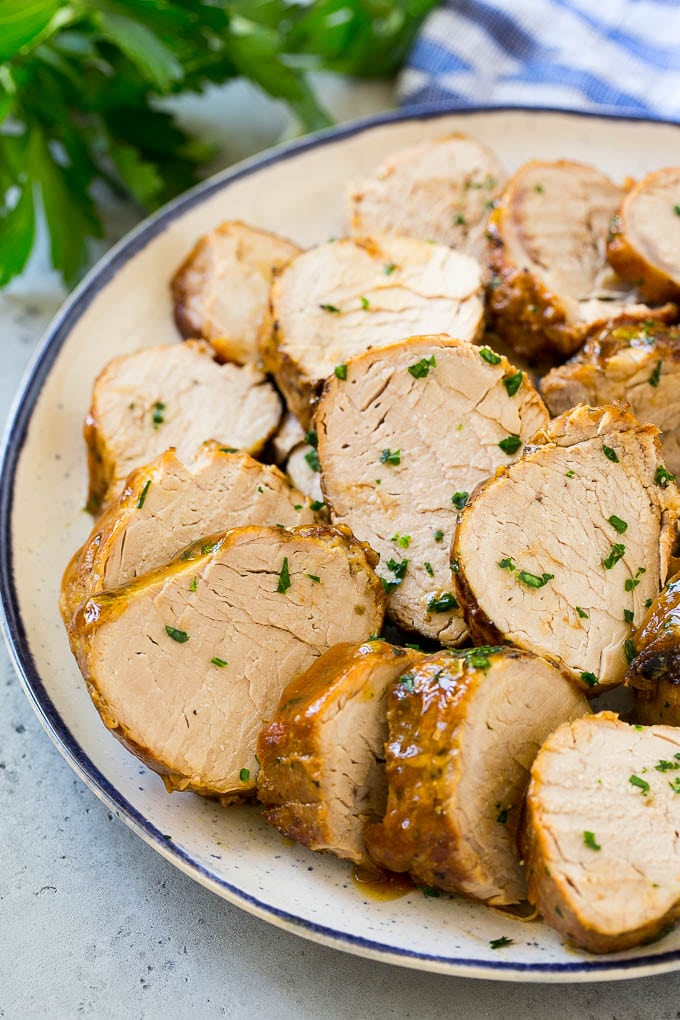 Slow Cooker Pork Tenderloin Recipe | Crock Pot Pork Tenderloin | Easy Pork Tenderloin #slowcooker #crockpot #pork #dinner #ezlod Sliced slow cooker pork tenderloin on a plate.