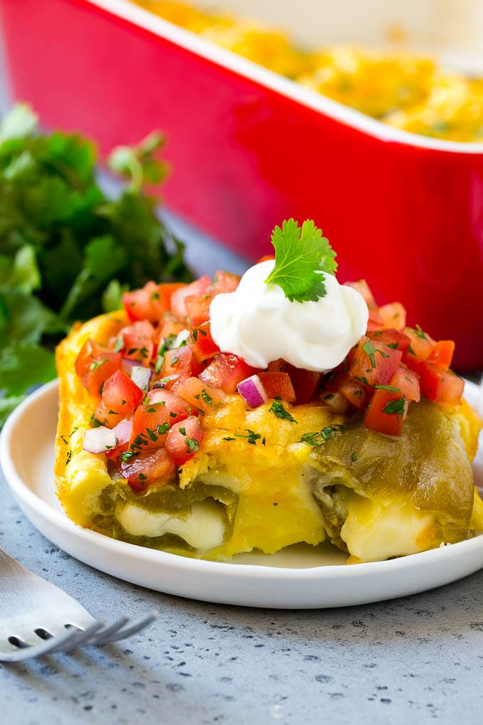 Chile Relleno Casserole Recipe | Baked Chile Rellenos | Mexican Casserole #casserole #chiles #mexican #cheese #dinner #ezlod A slice of chile relleno casserole with pico de gallo and sour cream on top.